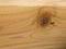 A square-edge piece of pine with wood burly grain knot.