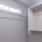 Square Empty walk in closet interior with small window carpet floor and white wall