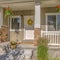 Square Exterior of sunlit home with pathway and stairs leading to porch and front door