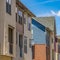 Square Exterior of townhouses against bright blue sky on a sunny day