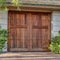 Square Facade of garage with wooden hinged door and gable roof in San Diego California