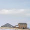 Square Facade of houses with a boundless cloudy sky background in winter