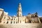 Square of the famous basilica Church of the Holy Cross. Historic city of Lecce, Italy. Blue sky cloudless