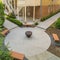 Square Fire pit outside a residential building with white siding stone wall and stairs