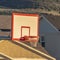 Square Focus on a basketball ring and board against houses on a sunny day