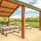 Square Focus on a pavilion at a park with tables and benches under the green roof