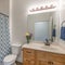 Square frame Bathroom with wooden vanity sink with flower vase and mirror