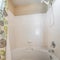 Square frame Bathtub and shower combo set in a bathroom with a shower curtain with floral design