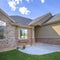 Square frame Beautiful exterior of home with brick wall landscaped yard and arched entryway