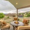 Square frame Chairs around table with fire pit at a residential balcony framed with railings