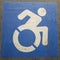 Square frame Close up of blue and white handicapped sign painted on a gray surface