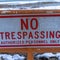 Square frame Close up of No Trespassing signage with snowy Utah Lake background in winter