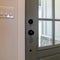 Square frame Close up of wooden front door of home with glass panel and black doorknob