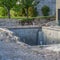 Square frame Construction of a residential swimming pool with houses and trees background