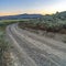 Square frame Curving dirt road with view of the valley and mountain against blue sky