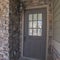 Square frame Entrance door to a house with feature brick wall
