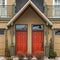 Square frame Entrance of townhouses with vibrant glass paned front doors and garage doors