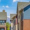 Square frame Exterior of townhouses against bright blue sky on a sunny day