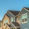 Square frame Exterior of upper storey of townhomes with blue sky background on a sunny day