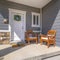 Square frame Facacde of a home with furniture on the welcoming sunlit porch