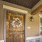 Square frame Facade of a home with rocking chairs on the porch and wreath on the front door