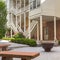 Square frame Fire pit and stone benches against building with stone brick wall and staircases