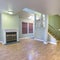 Square frame Fireplace by stairs in empty townhome