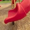 Square frame Focus on the colorful playground equipment at a park with red closed tube slide