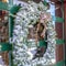 Square frame Frosted wreath on the glass wall of building that reflects the winter landscape