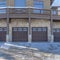 Square frame Garage door under the balcony of a snowy home in Park City Utah neighborhood