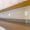 Square frame Gleaming brown countertop inside the kitchen of a new house