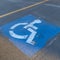 Square frame Handicapped parking space at a parking lot outside a building on a sunny day
