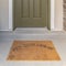 Square frame Hey good looking words on the brown doormat by the front door of a home