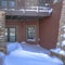 Square frame Home with balcony over snowy entrance built on Wasatch Mountain neighborhood