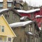 Square frame Home exteriors with horizontal wall siding and thick snow on the roofs