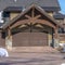 Square frame Home in Park City Utah in winter with gabled garage entrance against blue sky