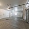 Square frame Interior of a garage with double automatic doors and concrete floor