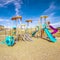 Square frame Kids playground with colorful blue slides during day