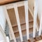 Square frame Looking down on U shaped indoor staircase with white baluster and brown handrail