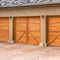 Square frame Luxurious exterior of a house with stylish brown wooden garage doors