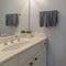 Square frame Neat small white bathroom interior in house