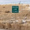 Square frame Passing Lane road sign at the side of a highway against grassy and snowy slope