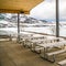 Square frame Picnic pavilion overlooking a snowy winter landscape of lake and mountain