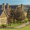 Square frame Residential scenery with pathways and grassy field in front of charming houses