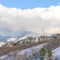 Square frame Row of homes on pristine snowy slope with unobstructed view of Wasatch Mountains