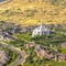 Square frame Salt Lake City Utah suburbs with a white temple towering over houses and roads