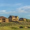 Square frame Sand trap and fairway at a golf course with multi storey homes in the background