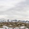 Square frame Scenic winter landscape with cloudy sky over striking mountain and hill homes