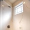 Square frame Shiny bathtub and shower inside the bathroom of a home with white wall