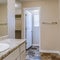 Square frame Sink and mirror in front of bathtub and shower stall inside tile floor bathroom